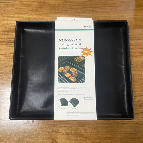 A grill tray featuring a flexible PTFE-coated fiberglass non-stick cooking surface framed by a sturdy stainless steel border for stability and easy handling.