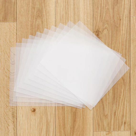 A bulk pack of frosted clear pre-cut disposable cutting board sheets flat-packed in a transparent OPP bag.