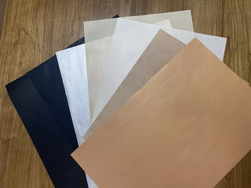 A fan-shaped showcase of custom PTFE grill mat thickness formulations and color variations including copper, brown, white, silver, and black.