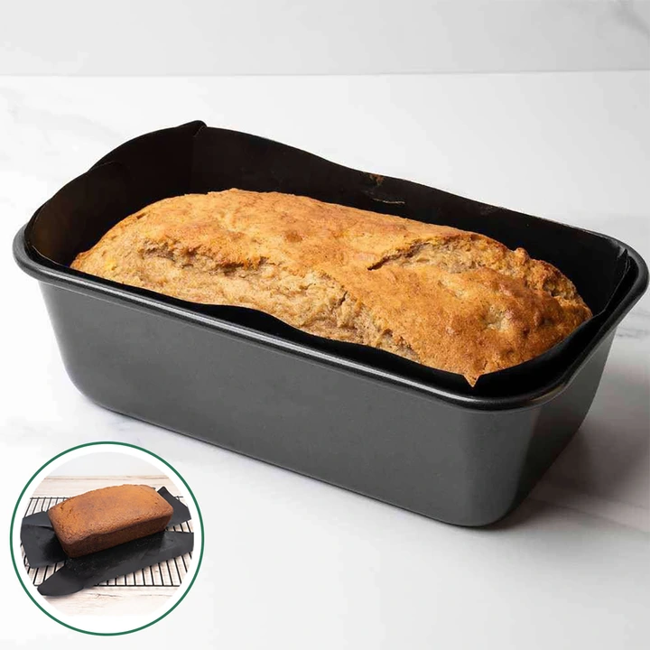 A non-stick black ptfe loaf pan liner insert releasing freshly baked banana bread from a baking tin.