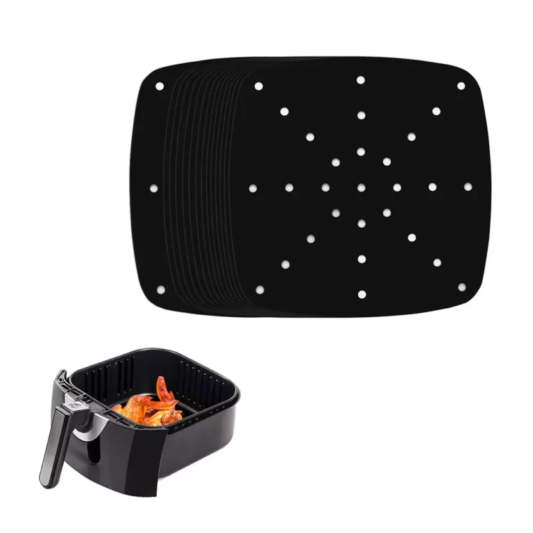 A black square with rounded corners perforated PTFE air fryer liner sheet showcased next to an appliance basket for bulk wholesale.