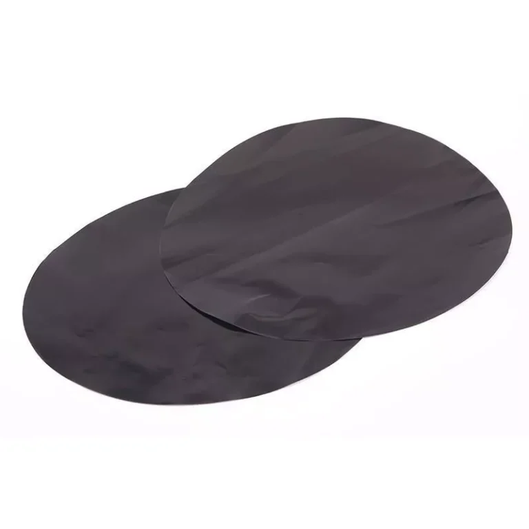 Multiple charcoal black round PTFE baking mat disks stacked together, highlighting smooth precision die-cut edge profiles for bulk wholesale.