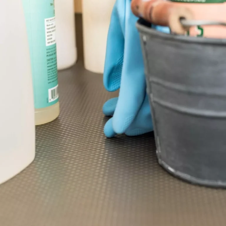Premium **peva under sink mat wholesale** rolls installed inside a kitchen cabinet to protect against water bucket leaks and detergent spills.